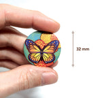 badge métal finition matte papillon viva catrina